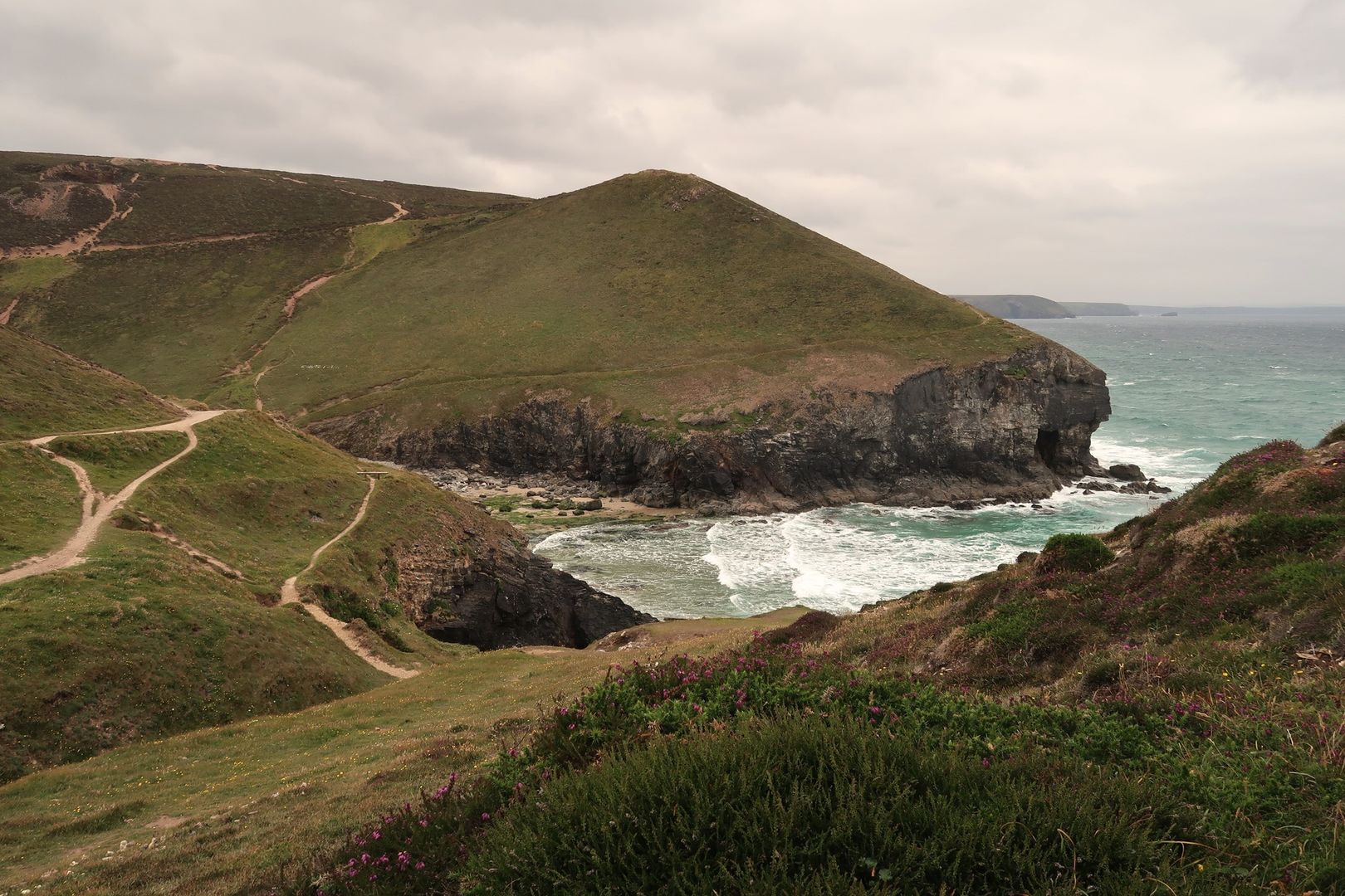 South West Coast Path winding above rugged Atlantic cliffs and surf